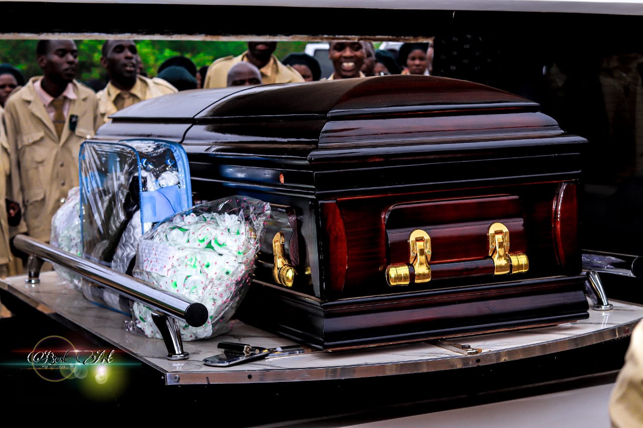 Casket and funeral attendants during ceremony